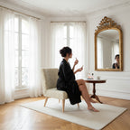 Vintage perfume bottles occasional chair with a woman in black silk robe sitting on it