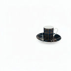 Winter heritage plaid mugs with a matching saucer on a white background