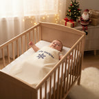 Baby in a cot wearing llttle helper christmas baby sleeping bag